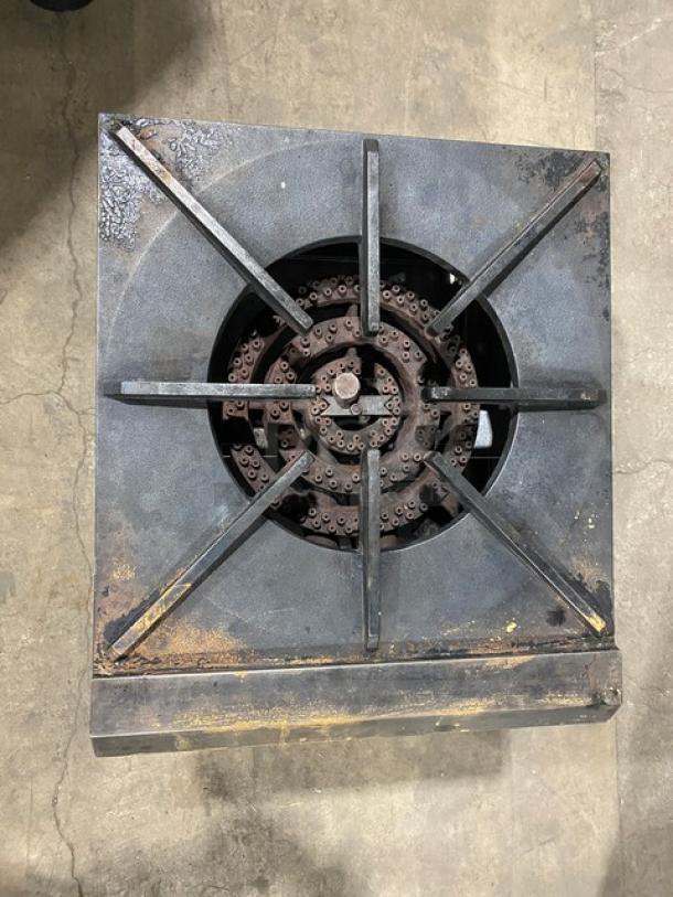 Commercial stainless steel natural gas stock pot range, single burner, on casters, used condition, visible wear.