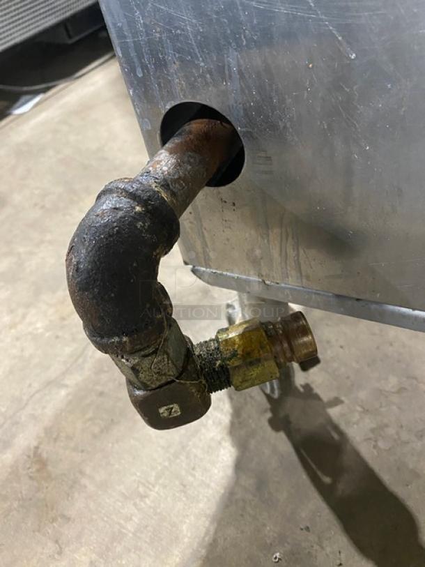 Commercial stainless steel natural gas single burner stock pot range, on casters, visible gas connection, used condition.