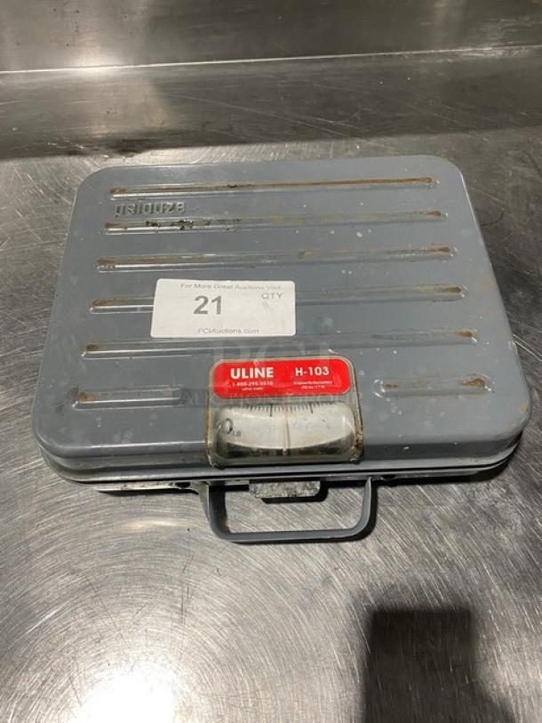 Rubbermaid Pelouze commercial briefcase-style analog shipping scale, model FG4100UD, 100 lb capacity, worn condition.