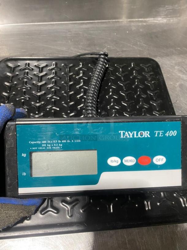 Taylor TE400 digital receiving scale, black, 400 lb capacity, clear LED display, used condition, model markings visible.