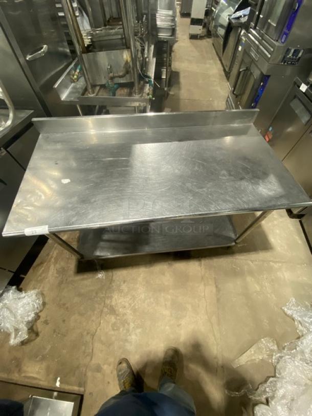 Commercial stainless steel worktop table with single undershelf and up-turned back splash. Gently used, sturdy condition.