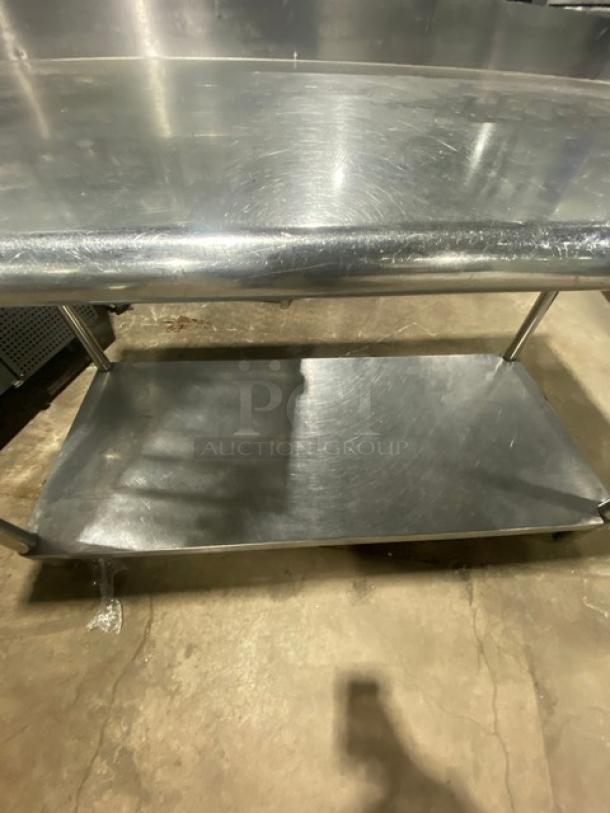 Commercial stainless steel undershelf worktop table with up-turned back splash, in good condition. Durable, versatile.