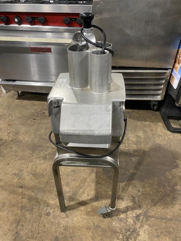 Robot Coupe CL50 Ultra food processor on metal stand with casters. Commercial-grade, continuous-feed design. Silver finish.