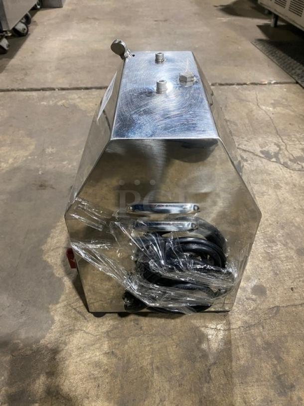 American Eagle stainless steel electric meat grinder, model AE-G22N, with packaging on legs, on concrete floor.