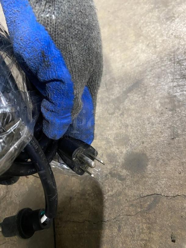 American Eagle AE-G22N commercial meat grinder plug and cord shown, model number visible, sturdy build, in used condition.