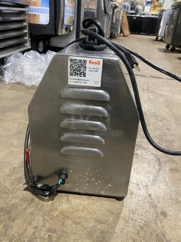 American Eagle AE-G22N stainless steel meat grinder, 115V, bench model on legs. Visible ResQ service tag with QR code.