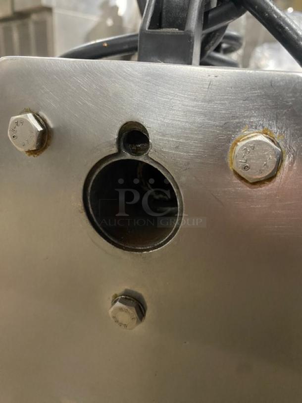 American Eagle AE-G22N commercial stainless steel electric meat grinder, 115V, on legs, bolts visible, used condition.