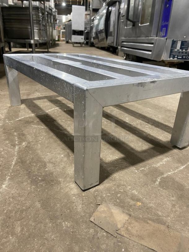 Commercial heavy-duty dunnage rack on legs, metal construction, durable and sturdy, ideal for storage, used condition.