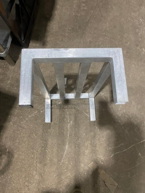 Commercial heavy-duty dunnage rack on legs, metallic finish, sturdy design, used condition, ideal for storage needs.