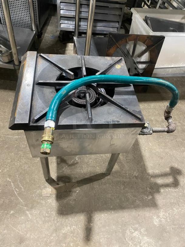 U.S. Range commercial stainless steel single burner stock pot range with gas connection hose, on legs, natural gas powered.