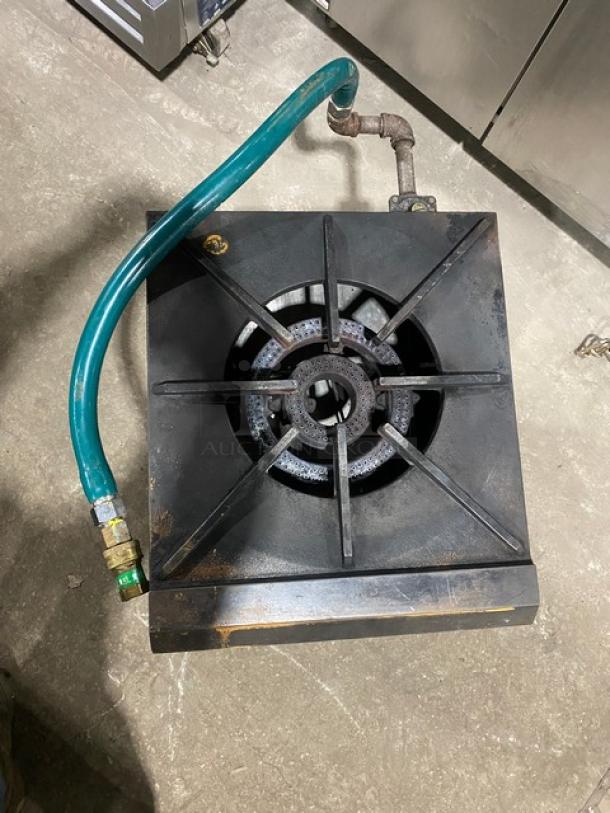 U.S. Range commercial stainless steel natural gas single burner stock pot range with gas connection hose, on legs.