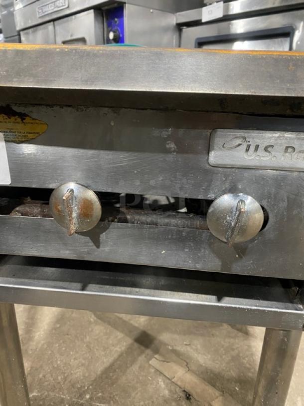 U.S. Range commercial stainless steel single burner stock pot range, natural gas, with gas connection hose, on legs.