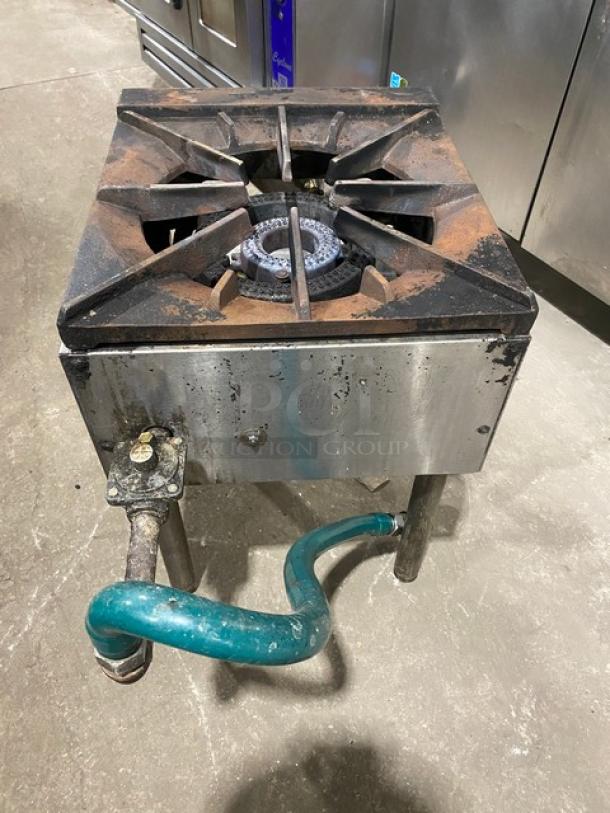 U.S. Range stainless steel natural gas single burner stock pot range with gas connection hose, on sturdy legs. Shows wear.