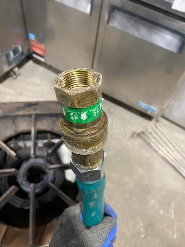 U.S. Range stainless steel natural gas single burner stock pot range with gas connection hose, shown on legs.