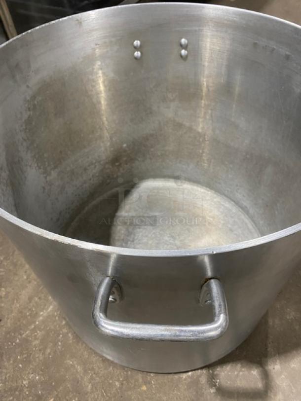 Commercial heavy-duty round stock pot with handles, metal, used condition, no visible brand markings, sturdy construction.
