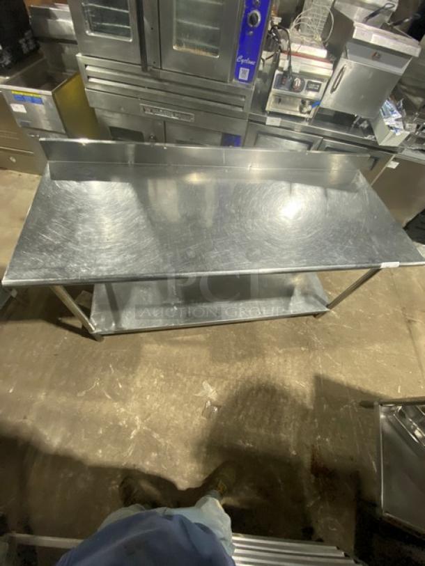 KCS stainless steel undershelf worktop table with upturned backsplash, on legs. Commercial use, good condition.
