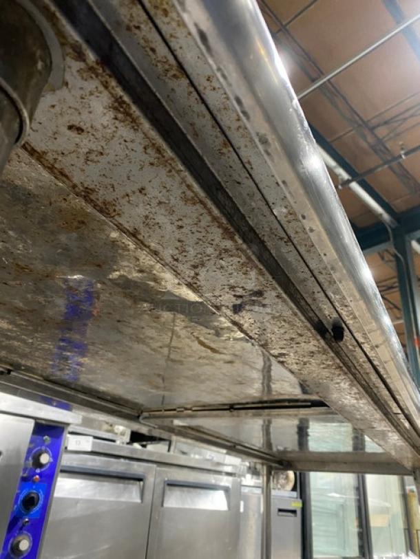 KCS Commercial Stainless Steel Single Undershelf Worktop Table with up-turned backsplash, visible wear, on sturdy legs.