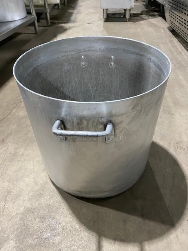 Heavy-duty commercial round stock pot with handles, metallic finish, large capacity, used condition, ideal for kitchens.