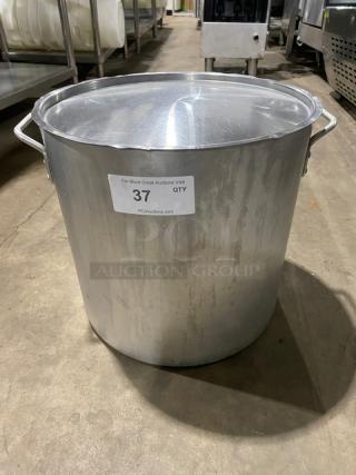 Commercial heavy-duty round stock pot with lid and handles, stainless steel, used condition. Label "37 QTY" visible.