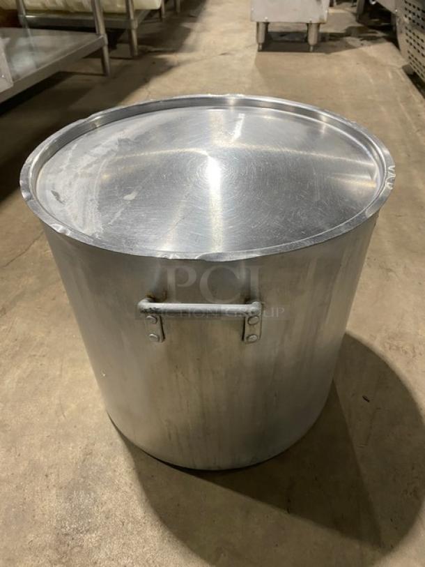 Commercial heavy-duty round stock pot with handles and lid. Made of durable metal, suitable for high-volume cooking.