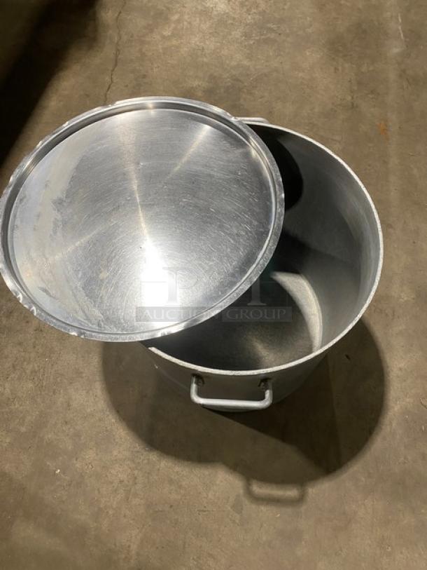 Commercial heavy-duty round stock pot with handles and lid. Made of stainless steel. Ideal for large-scale cooking.