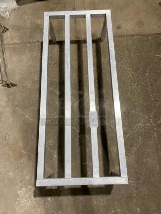 Commercial heavy duty dunnage rack on legs, metal construction, sturdy design, minor wear, ideal for storage needs.