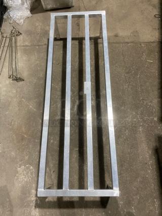 Commercial heavy-duty dunnage rack with legs, silver metal, excellent condition, ideal for storage, measures approximately 60" x 18".