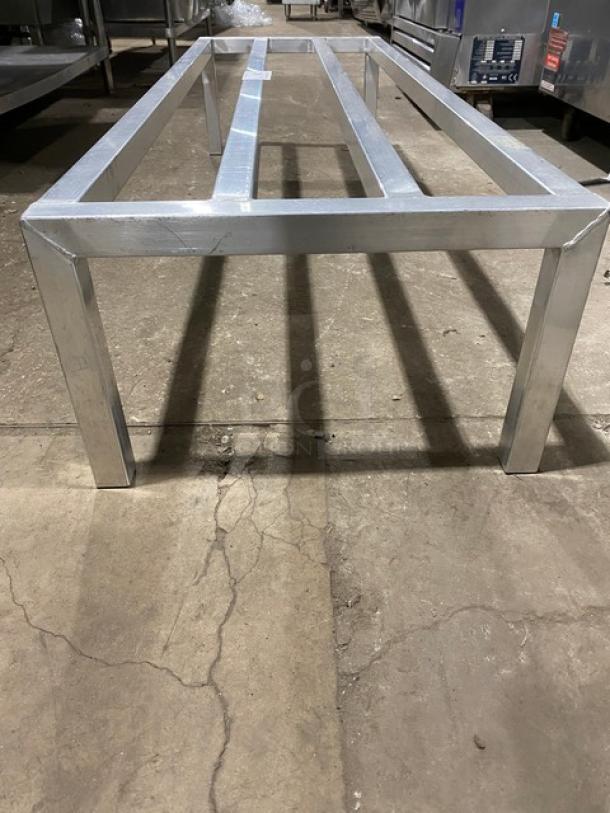 Commercial heavy-duty dunnage rack with aluminum frame on four sturdy legs, ideal for storage. Durable and in good condition.