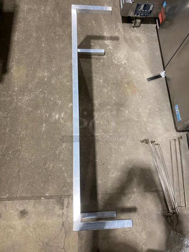 Commercial heavy-duty dunnage rack, aluminum construction, rectangular, elevated on legs, excellent condition, industrial use.