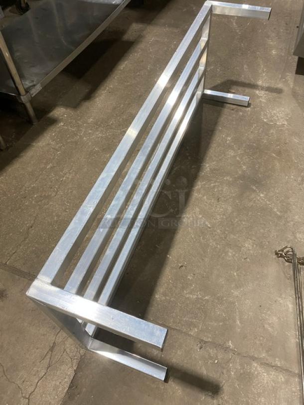 Commercial heavy-duty dunnage rack with a metal slatted design and sturdy legs, excellent condition, ideal for storage.