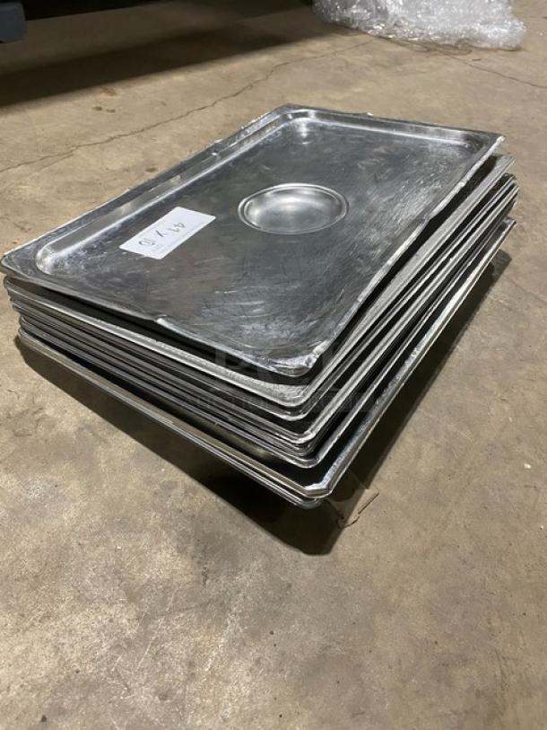 Stack of commercial stainless steel steamtable pan lids, gently used condition. Visible label marked "A-10."