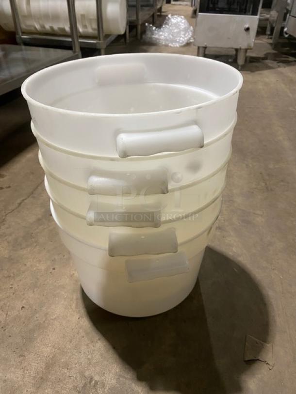 Commercial white round food storage containers with handles, stacked, ideal for bulk storage, durable plastic, clean condition.