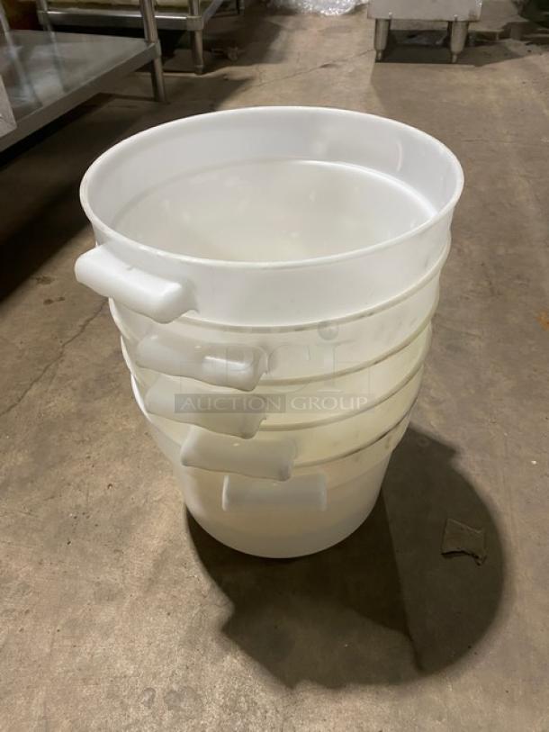 Commercial white round food storage containers with handles, stack of five, used condition.