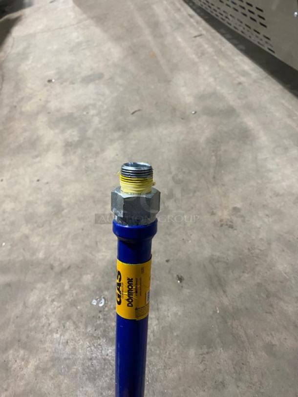 Dormont commercial blue gas connector hose with metal fittings, visible yellow label indicating gas use.