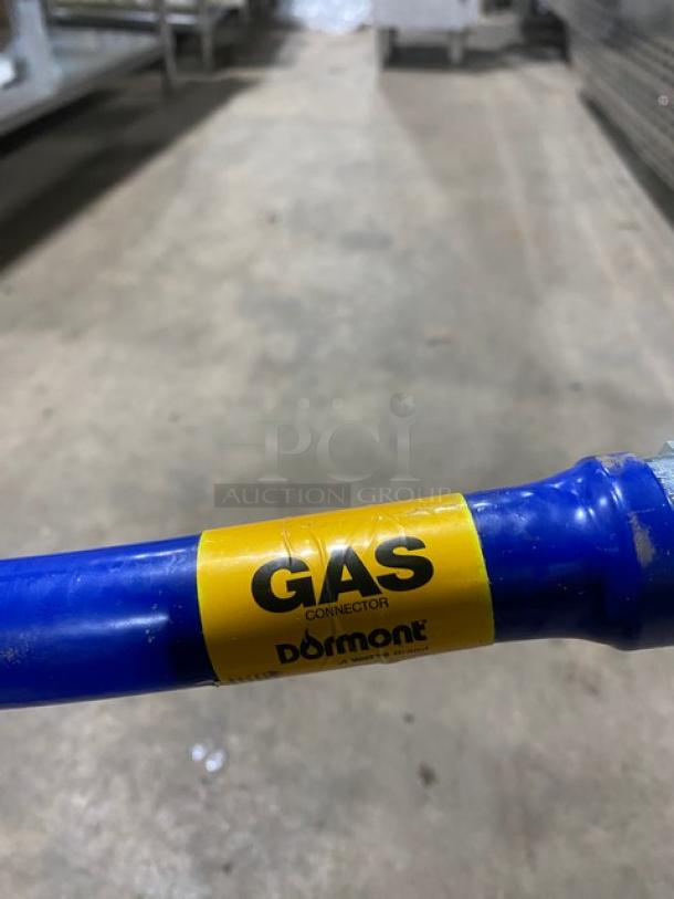 Dormont commercial blue gas connector hose with visible yellow label, in used condition. Suitable for gas appliances.