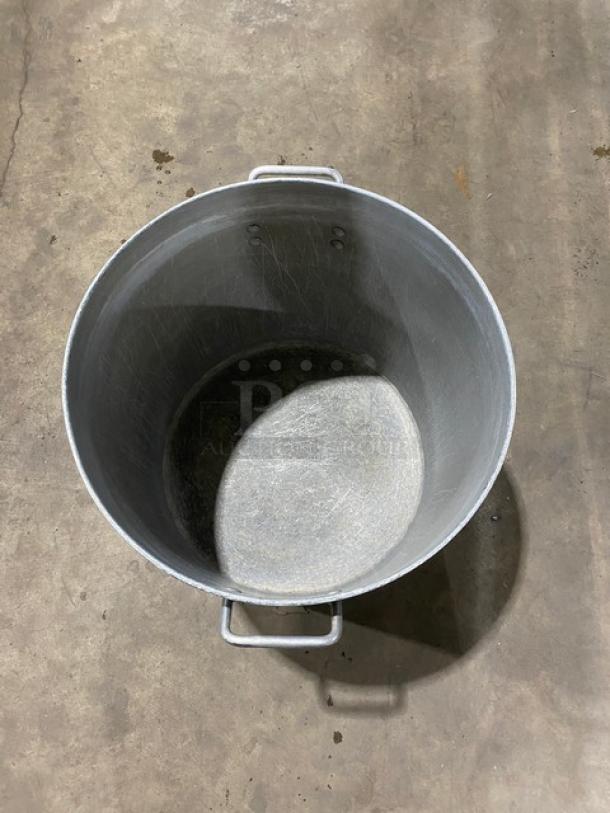 Commercial heavy-duty round stock pot with handles, metal construction, moderate wear, ideal for large-scale cooking.