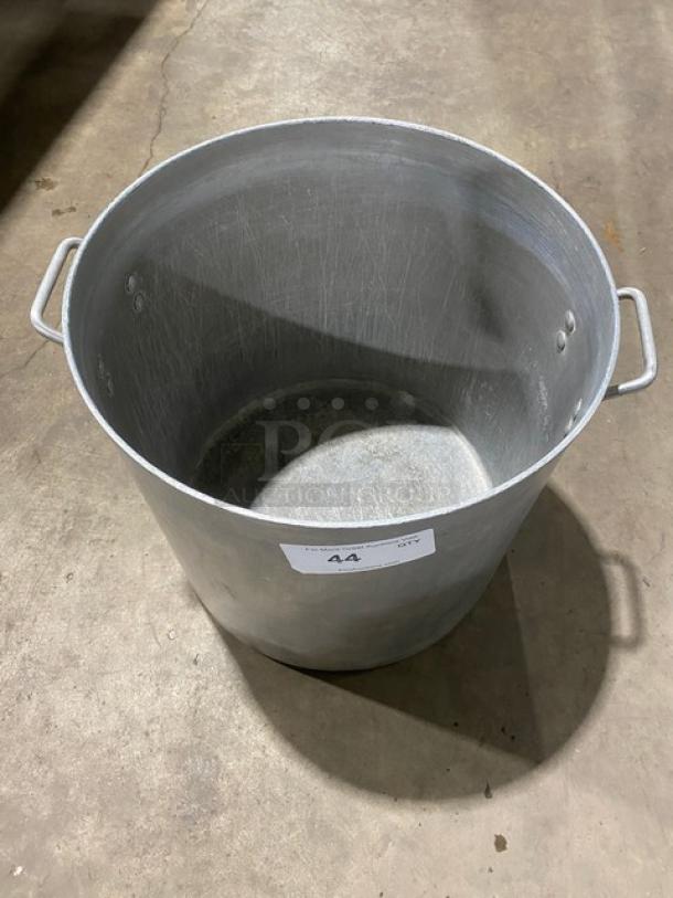 Commercial heavy-duty round stock pot with handles, metal construction, visible wear, auction label "44."