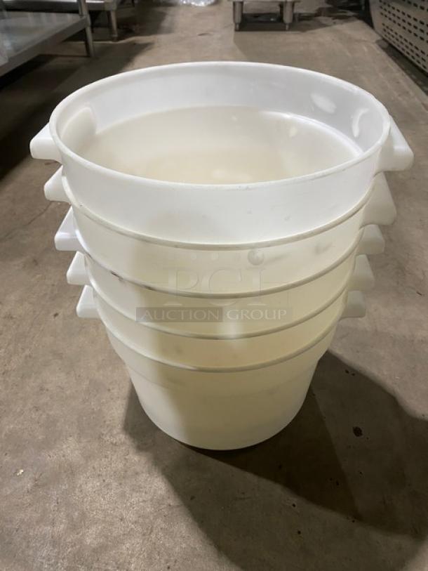 Commercial white round food storage containers with handles, stacked, used for bulk storage, durable plastic material.