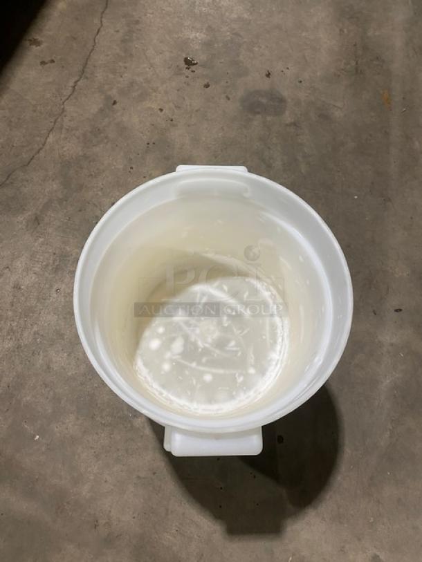 Commercial white round food storage container with handles, used. Visible wear on interior. Ideal for bulk storage.