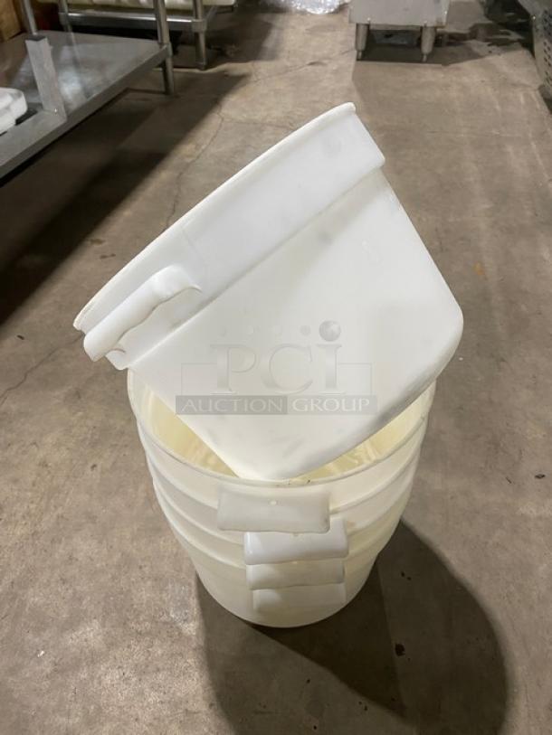 White round commercial food storage containers with handles, stacked. Clean and well-maintained.
