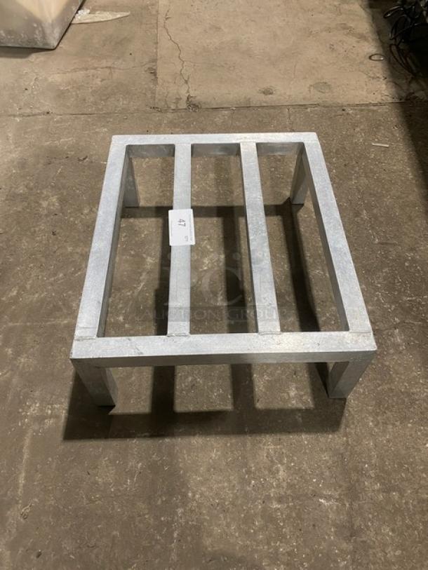 Commercial heavy-duty dunnage rack on legs, metal construction, used for storage, shows number tag "47" attached.