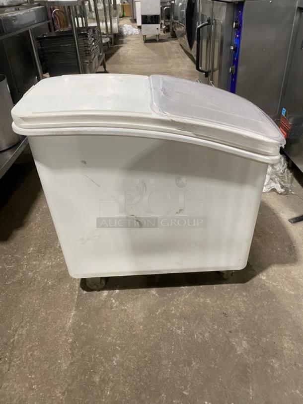 Commercial white portable food ingredient bin with clear lid. Features casters for mobility. Minor scratches visible.