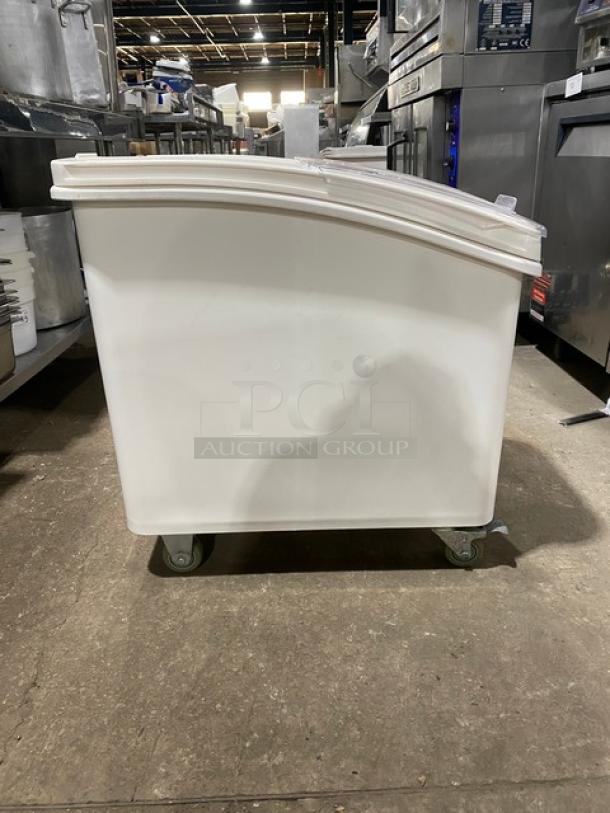 Winco commercial white portable food ingredient bin with clear lid, on casters, in used condition.