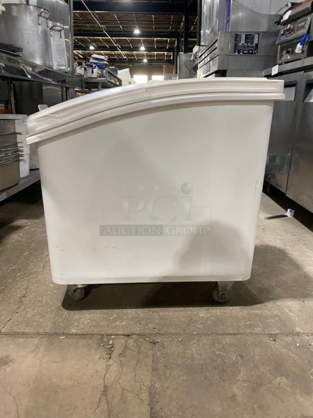Winco commercial white portable food ingredient bin with clear lid, on casters, in good condition, ideal for kitchen use.