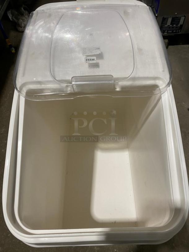 Winco commercial white portable food ingredient bin with clear lid, on casters. Clean, well-maintained, visible label details specs.