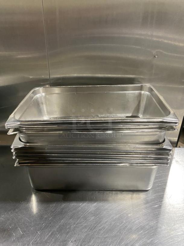 Stack of commercial stainless steel hotel pans on a countertop, showing durable build and clean surfaces.