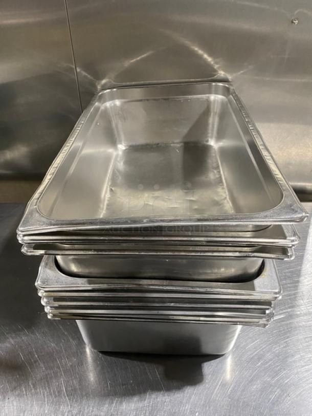 Stack of commercial stainless steel hotel steamtable pans in excellent condition, ideal for professional kitchens.