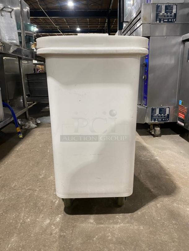 Winco commercial white portable food storage bin with clear lid, on casters. Used condition. Ideal for kitchen storage.