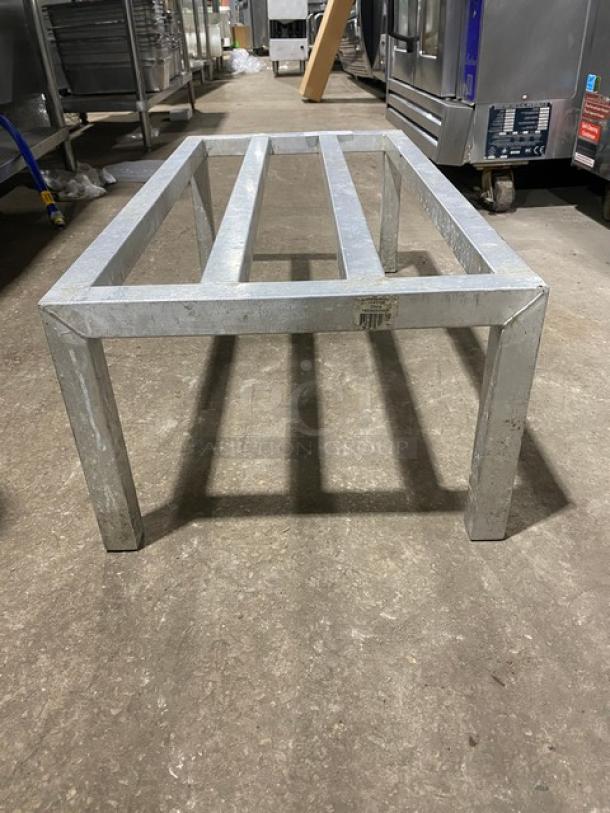 Heavy duty commercial dunnage rack on legs, metal construction, sturdy design, excellent condition, suitable for storage.