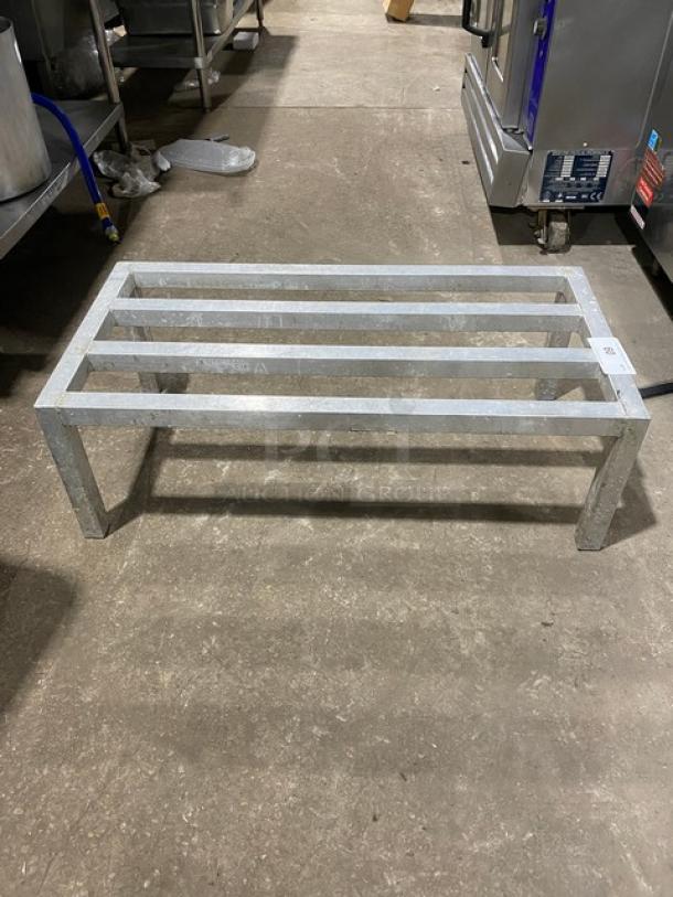 Commercial heavy-duty metal dunnage rack on legs, rectangular, sturdy construction, suitable for heavy storage.